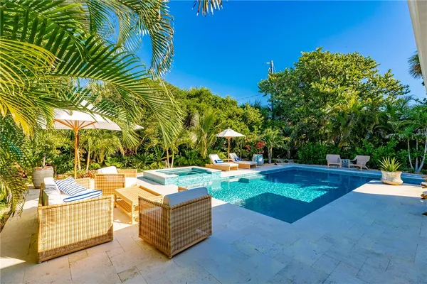 a view of a backyard with swimming pool