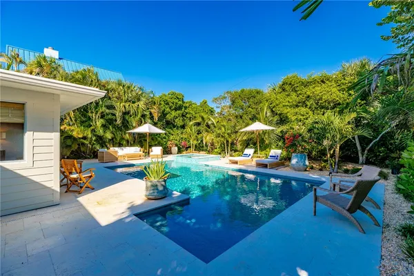 a view of a backyard with sitting area