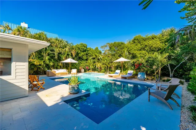 a view of a backyard with sitting area