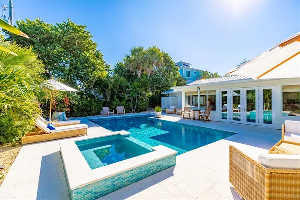 a view of a house with swimming pool and sitting area