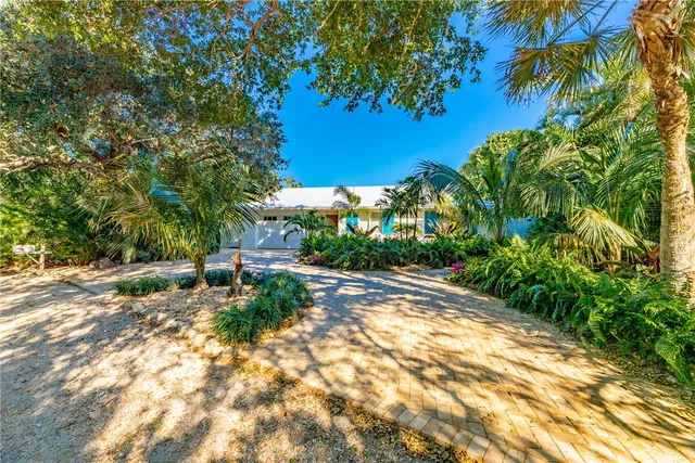 an aerial view of a house with a yard and outdoor seating