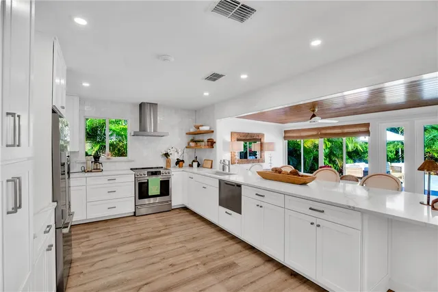 a kitchen with white cabinets and white appliances