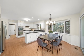2130 Mallard Drive Northbrook, IL 60062 - Photo 15 of 28 a kitchen with a dining table chairs wooden floor and appliances