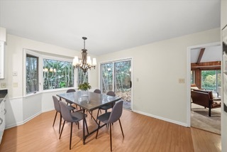 2130 Mallard Drive Northbrook, IL 60062 - Photo 16 of 28 a dining room with furniture wooden floor a potted plant and a chandelier