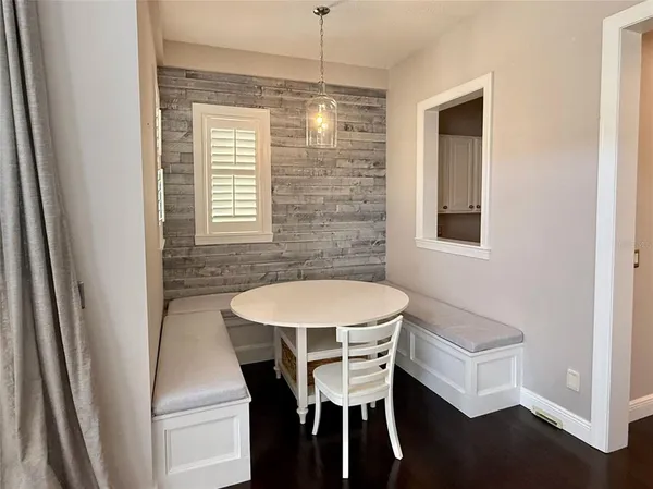 a room with a chair and cabinets