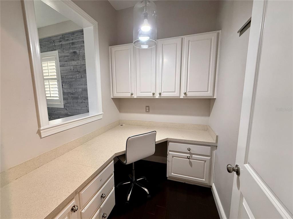 1328 Celebration Avenue Celebration, FL 34747 - Photo 12 of 26 a room with a chair and cabinets