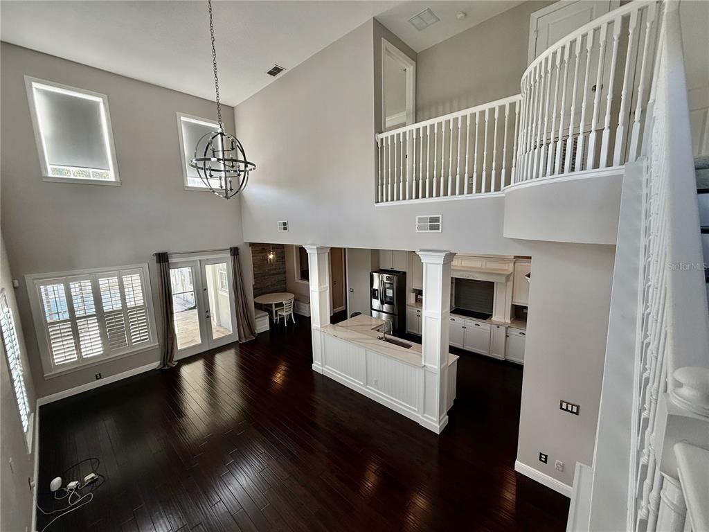 1328 Celebration Avenue Celebration, FL 34747 - Photo 19 of 26 a view of a livingroom with wooden floor and stairs