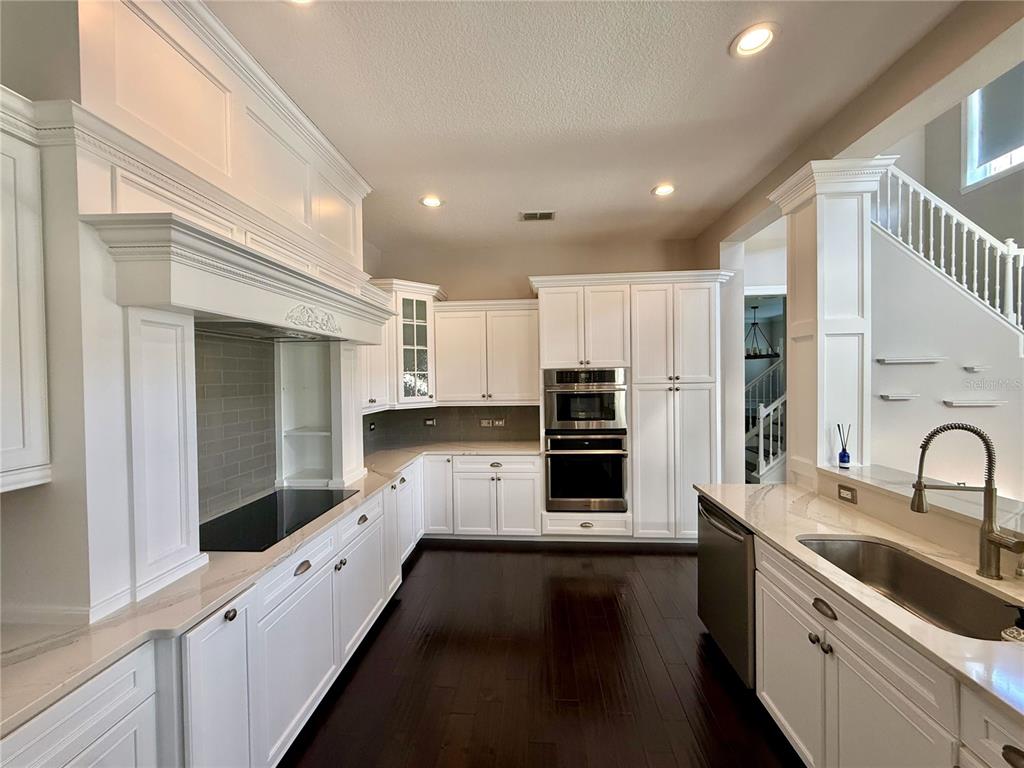 1328 Celebration Avenue Celebration, FL 34747 - Photo 8 of 26 a kitchen with stainless steel appliances a sink a stove a refrigerator and cabinets