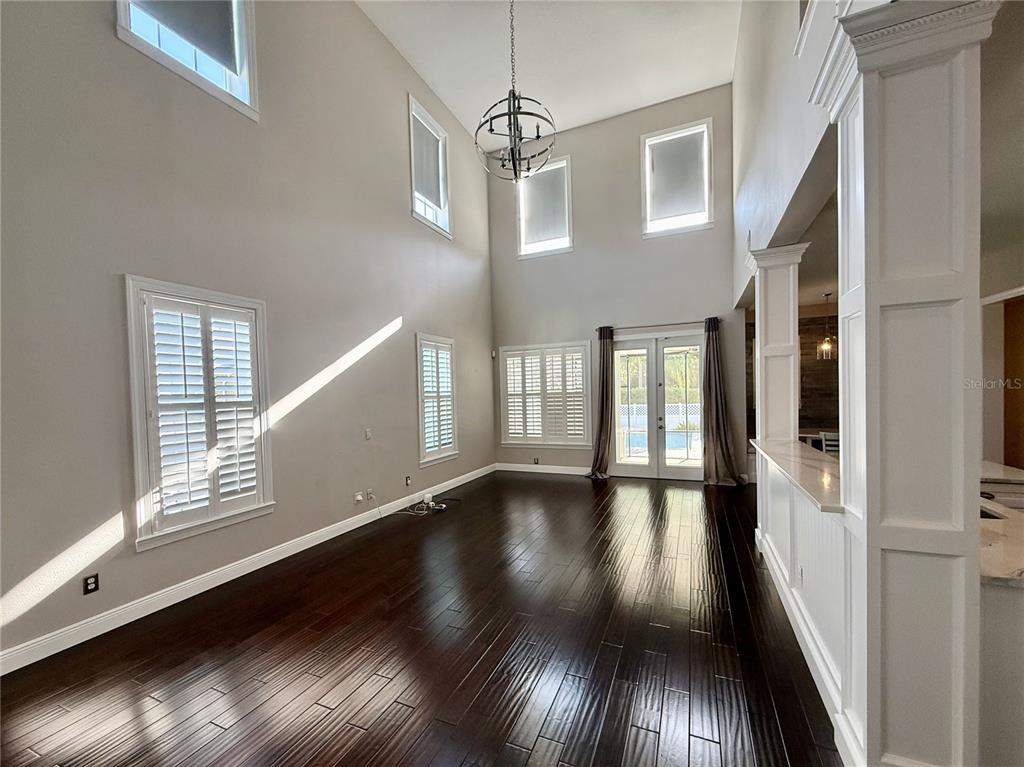 1328 Celebration Avenue Celebration, FL 34747 - Photo 10 of 26 a view of an empty room with wooden floor and windows