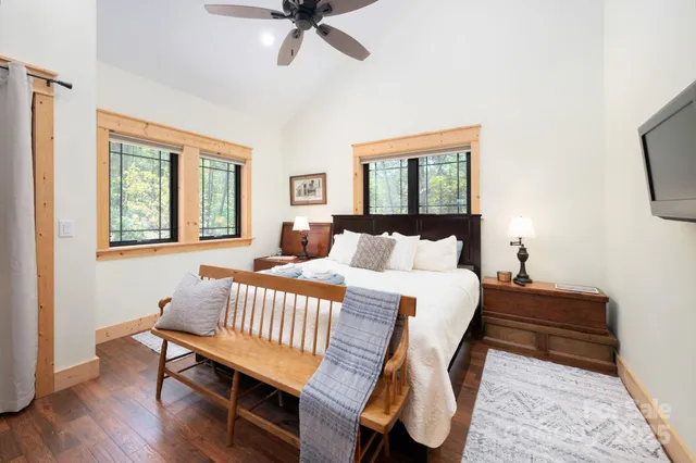 a bedroom with a bed and dresser with mirror