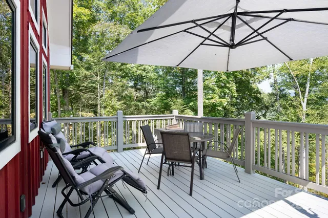 an aerial view of a house with a yard and lake view