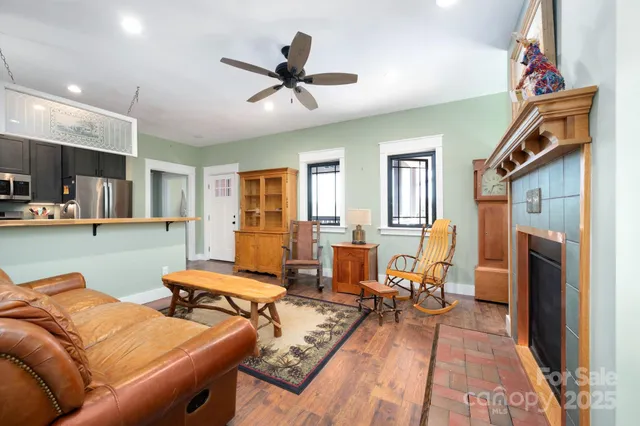 a living room with furniture and a dining table with kitchen view