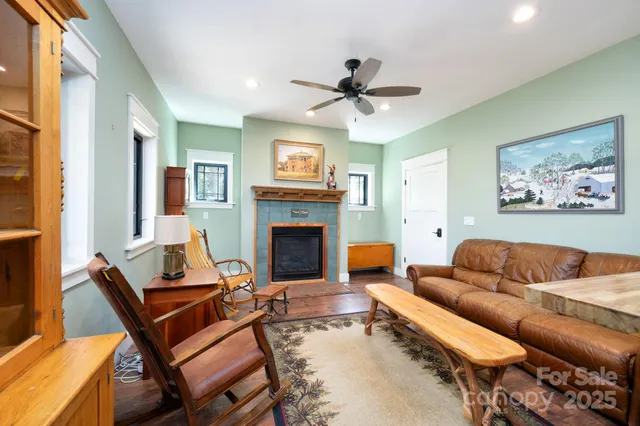 a living room with furniture a fireplace and a flat screen tv