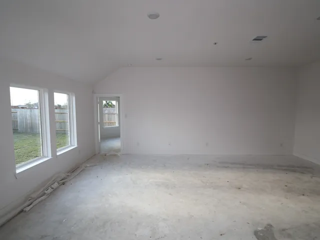 a view of an empty room with windows