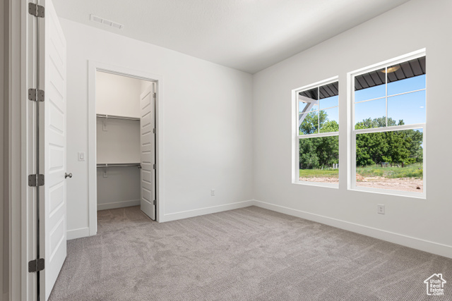 549 North Legend Circle, Unit C/466 Mapleton, UT 84664 - Photo 34 of 39 Unfurnished bedroom featuring carpet and a walk in closet