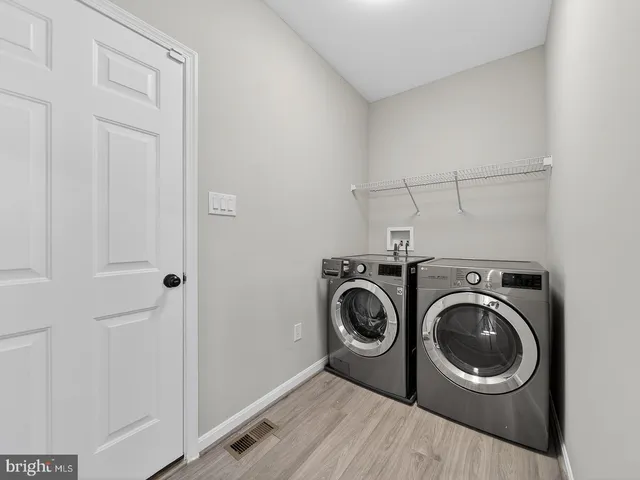 a large kitchen with granite countertop a large counter top stainless steel appliances and cabinets