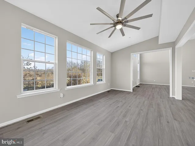 a bathroom with a granite countertop sink a window and shower