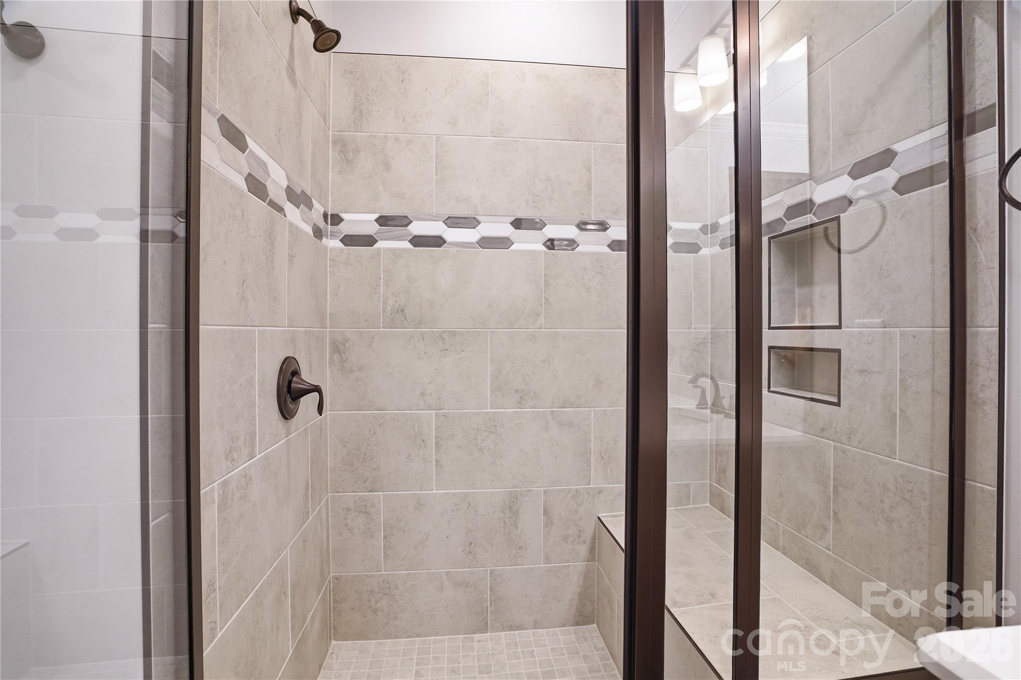 5562 Caneel Lane Denver, NC 28037 - Photo 28 of 44 a bathroom with a glass shower door