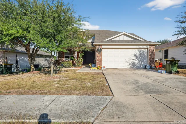 a view of garage with a table and chairs under an umbrella