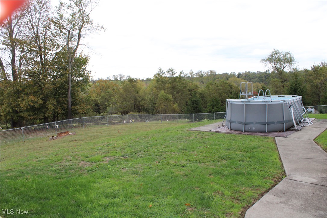 56 3rd Street Rayland, OH 43943 - Photo 9 of 46 Fenced backyard featuring a forest view
