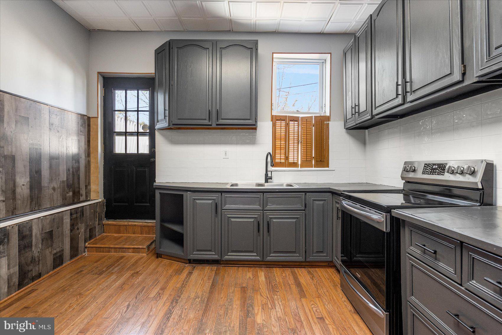 3526 Old York Road Baltimore, MD 21218 - Photo 10 of 33 a kitchen with granite countertop stainless steel appliances and wooden cabinets