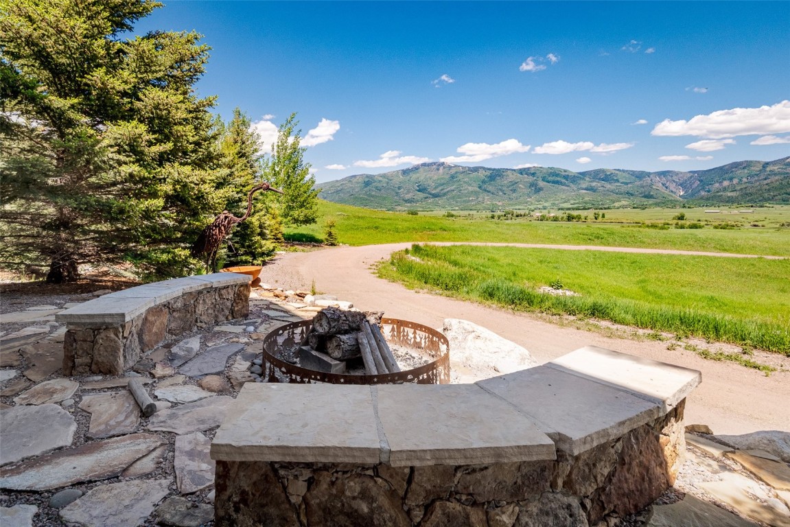 30855 Emerald Ridge Steamboat Springs, CO 80487 - Photo 19 of 50 a view of a swimming pool with a patio and a garden