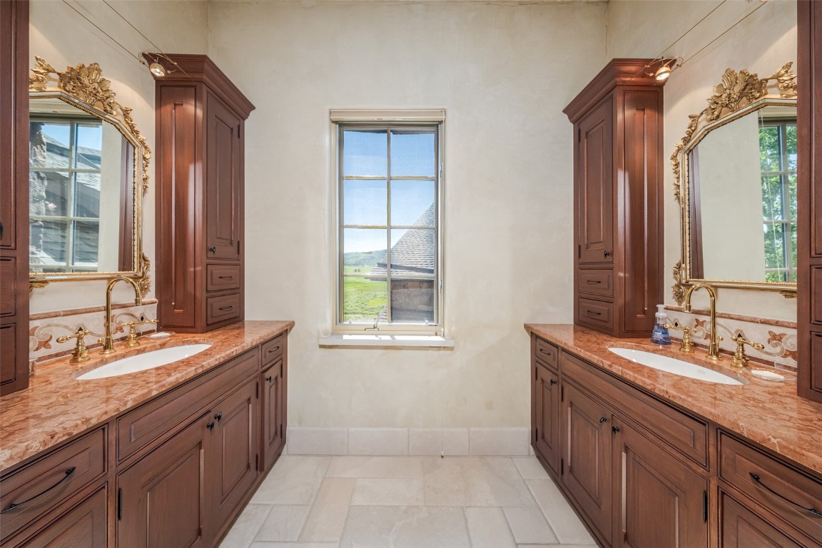 30855 Emerald Ridge Steamboat Springs, CO 80487 - Photo 35 of 50 a spacious bathroom with a granite countertop double vanity sink a mirror and a bathtub