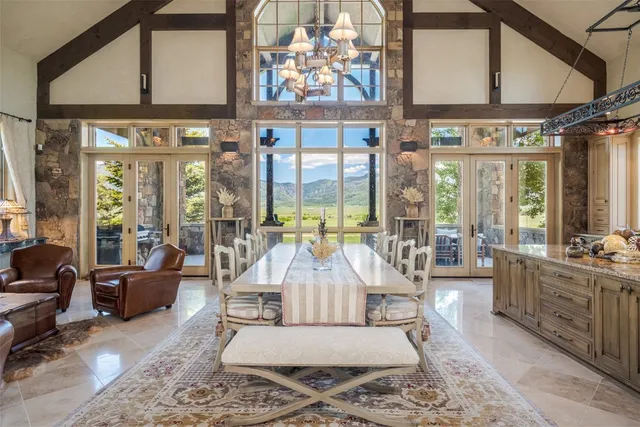 a living room with furniture and large windows