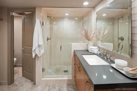 a bedroom with a bed and a dresser next to a window