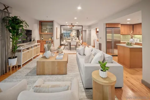 a living room with furniture a flat screen tv and a large window
