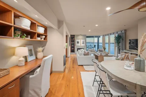 a living room with furniture a fireplace and a floor to ceiling window