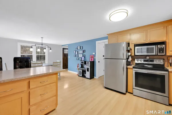 a living room with furniture a dining table and wooden floor