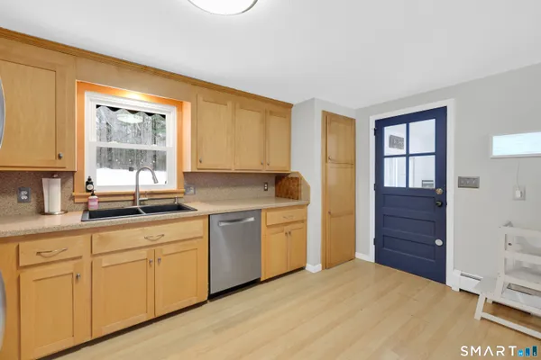 a kitchen with a refrigerator sink and cabinets
