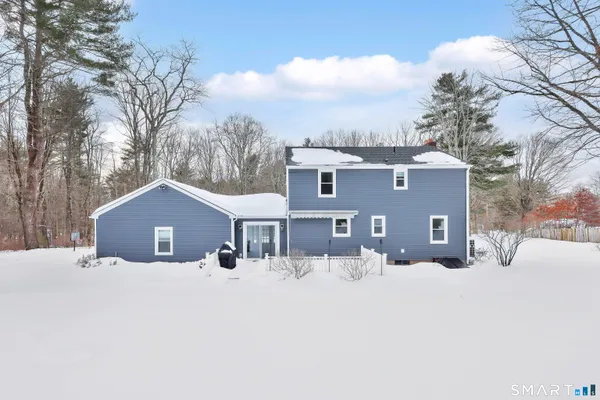 a view of a house with a snow in the yard