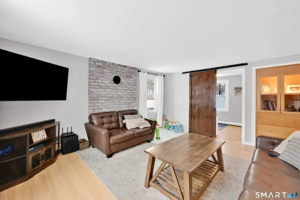 a living room with furniture and wooden floor