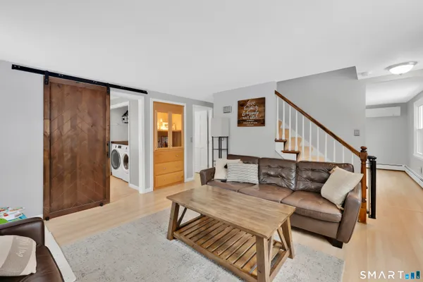 a bathroom with a sink vanity granite and toilet