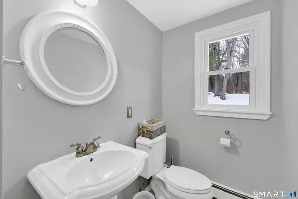 a bathroom with a sink a mirror and a toilet