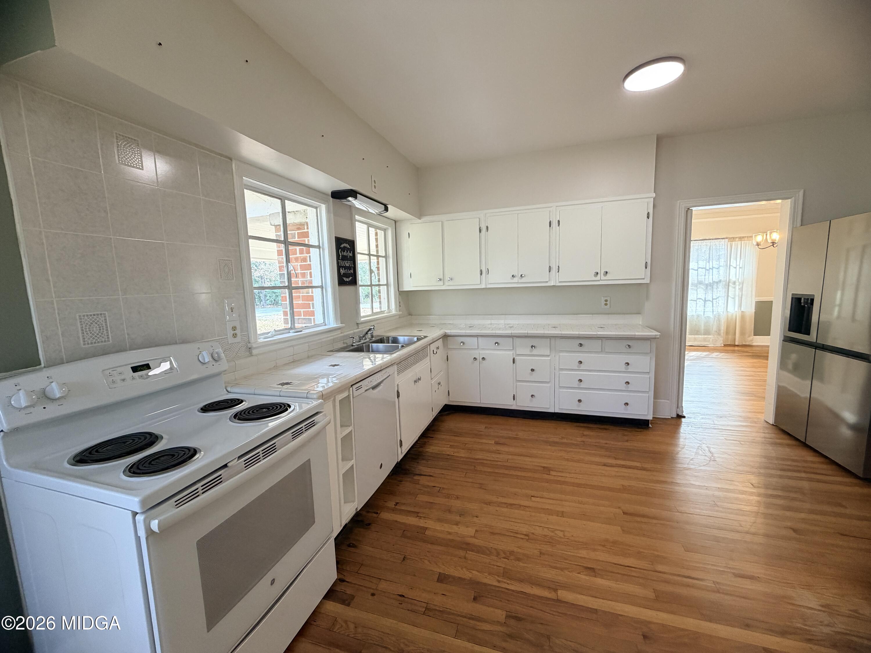 419 West Johnston Street Forsyth, GA 31029 - Photo 12 of 34 a kitchen that has a sink and a stove in it