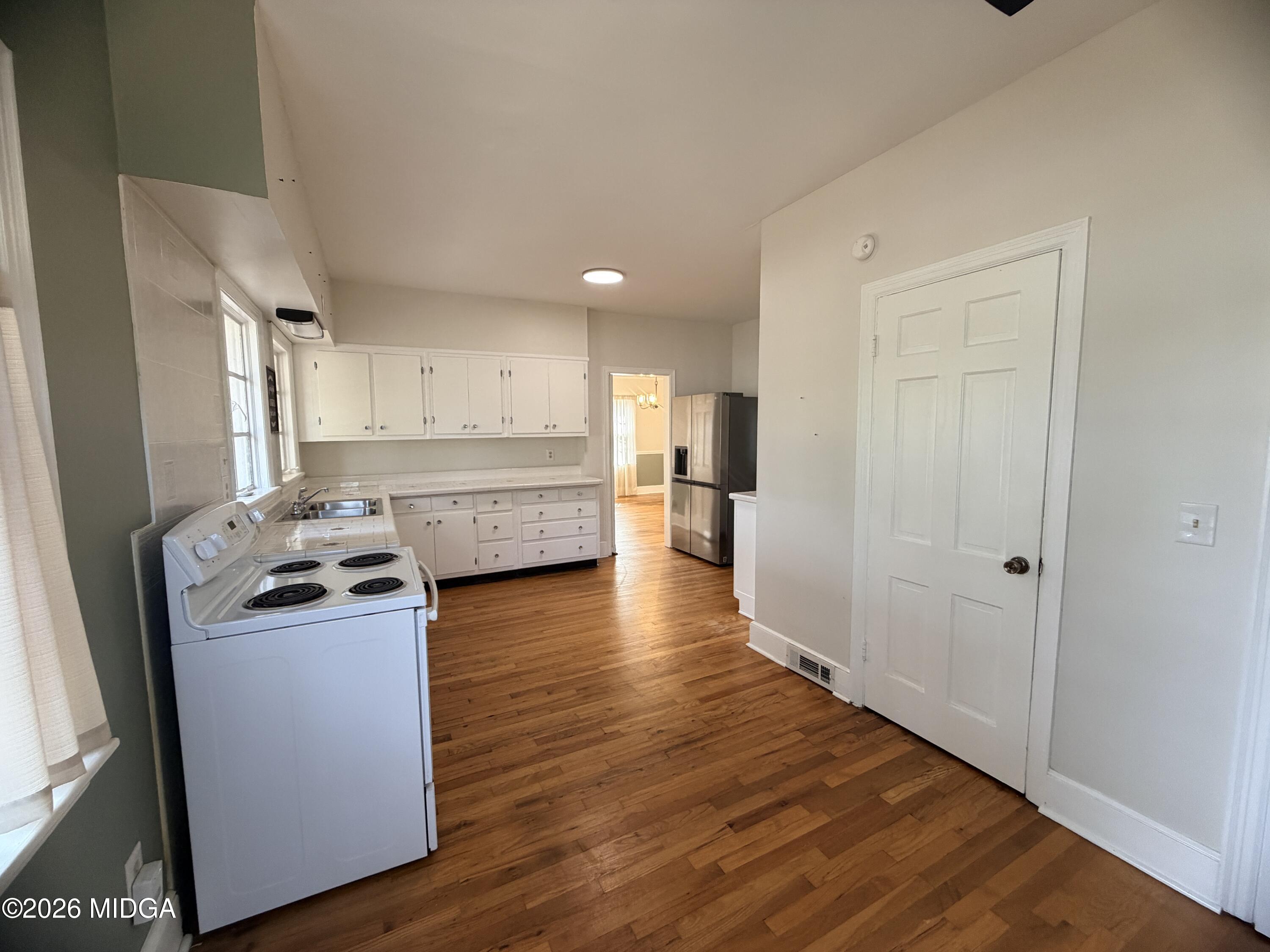 419 West Johnston Street Forsyth, GA 31029 - Photo 13 of 34 a kitchen with stainless steel appliances granite countertop a refrigerator and a stove top oven