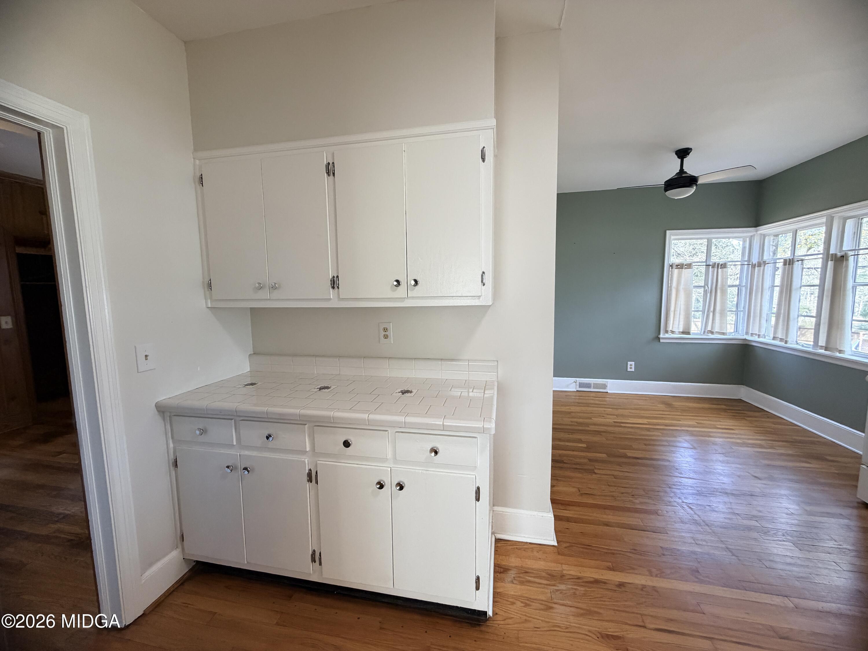 419 West Johnston Street Forsyth, GA 31029 - Photo 14 of 34 a view of cabinets and wooden floor