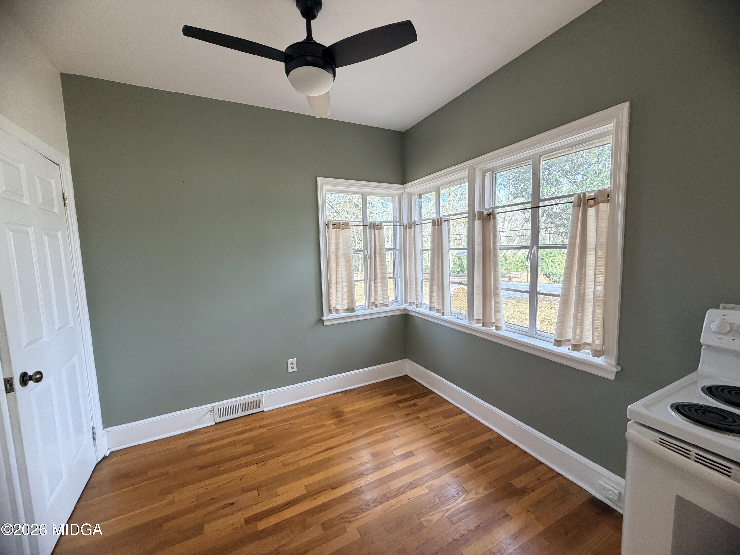 419 West Johnston Street Forsyth, GA 31029 - Photo 15 of 34 a view of empty room with wooden floor and fan