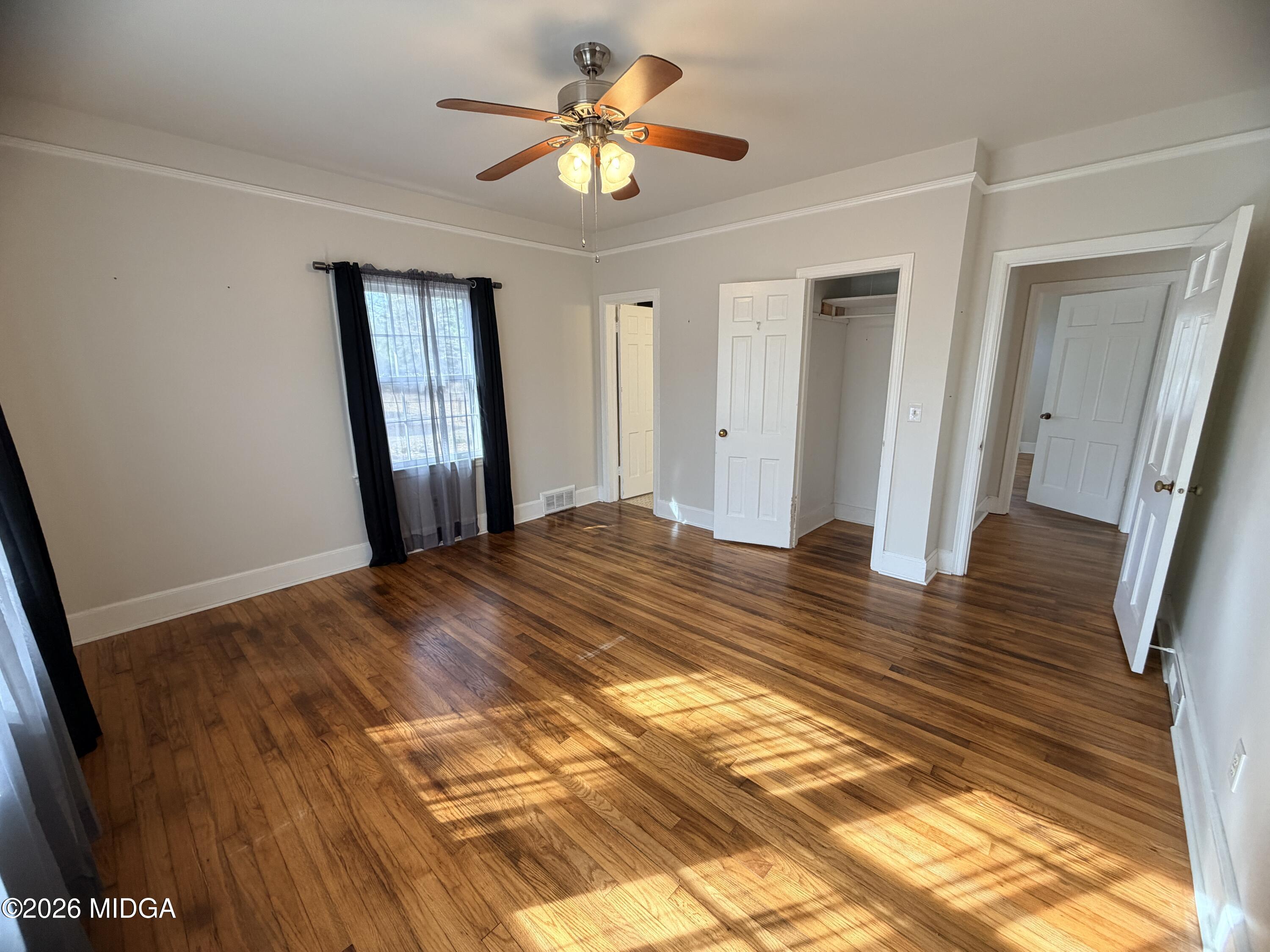 419 West Johnston Street Forsyth, GA 31029 - Photo 19 of 34 a view of a room with wooden floor and a ceiling fan