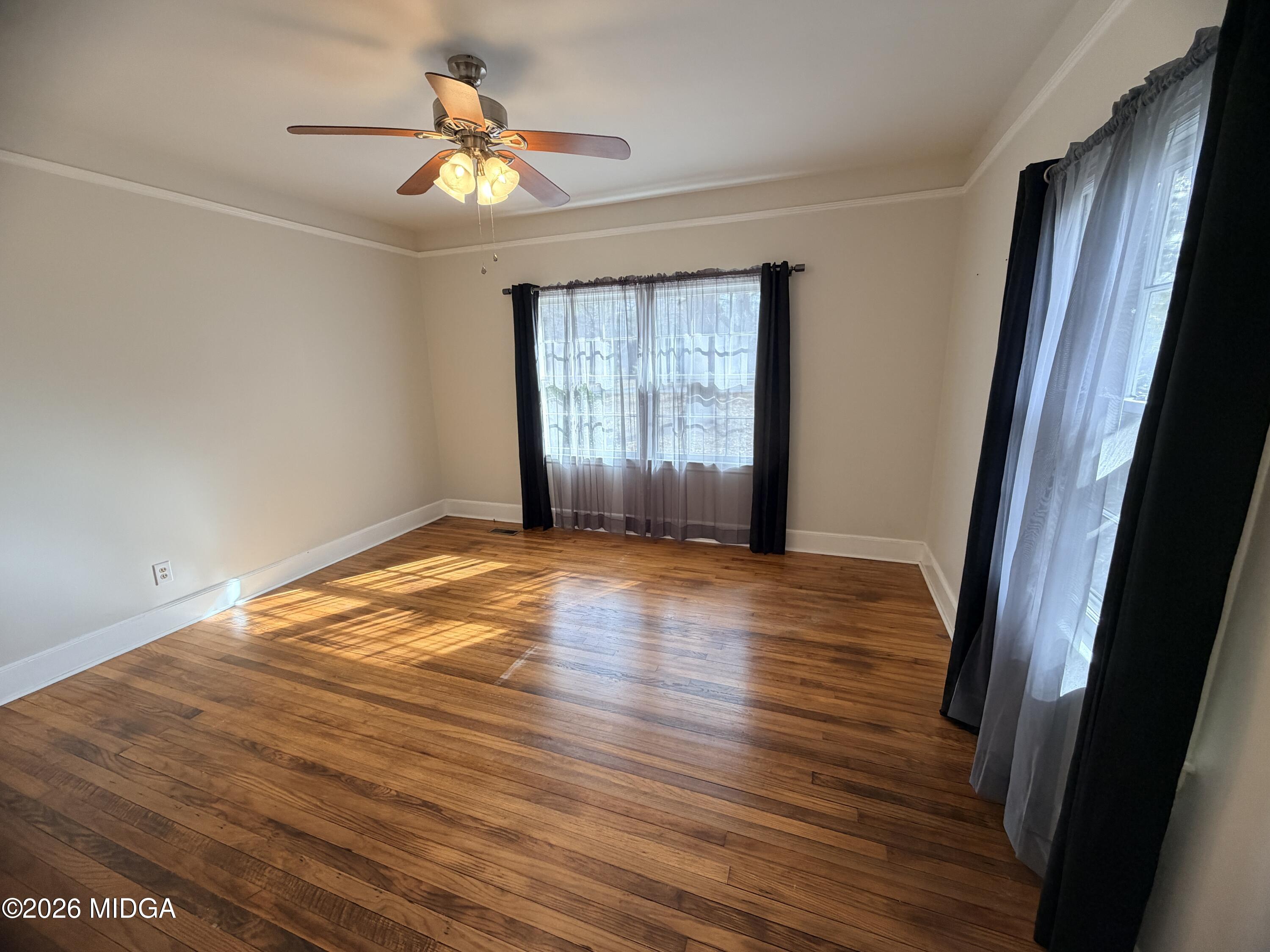 419 West Johnston Street Forsyth, GA 31029 - Photo 20 of 34 a view of empty room with wooden floor and fan