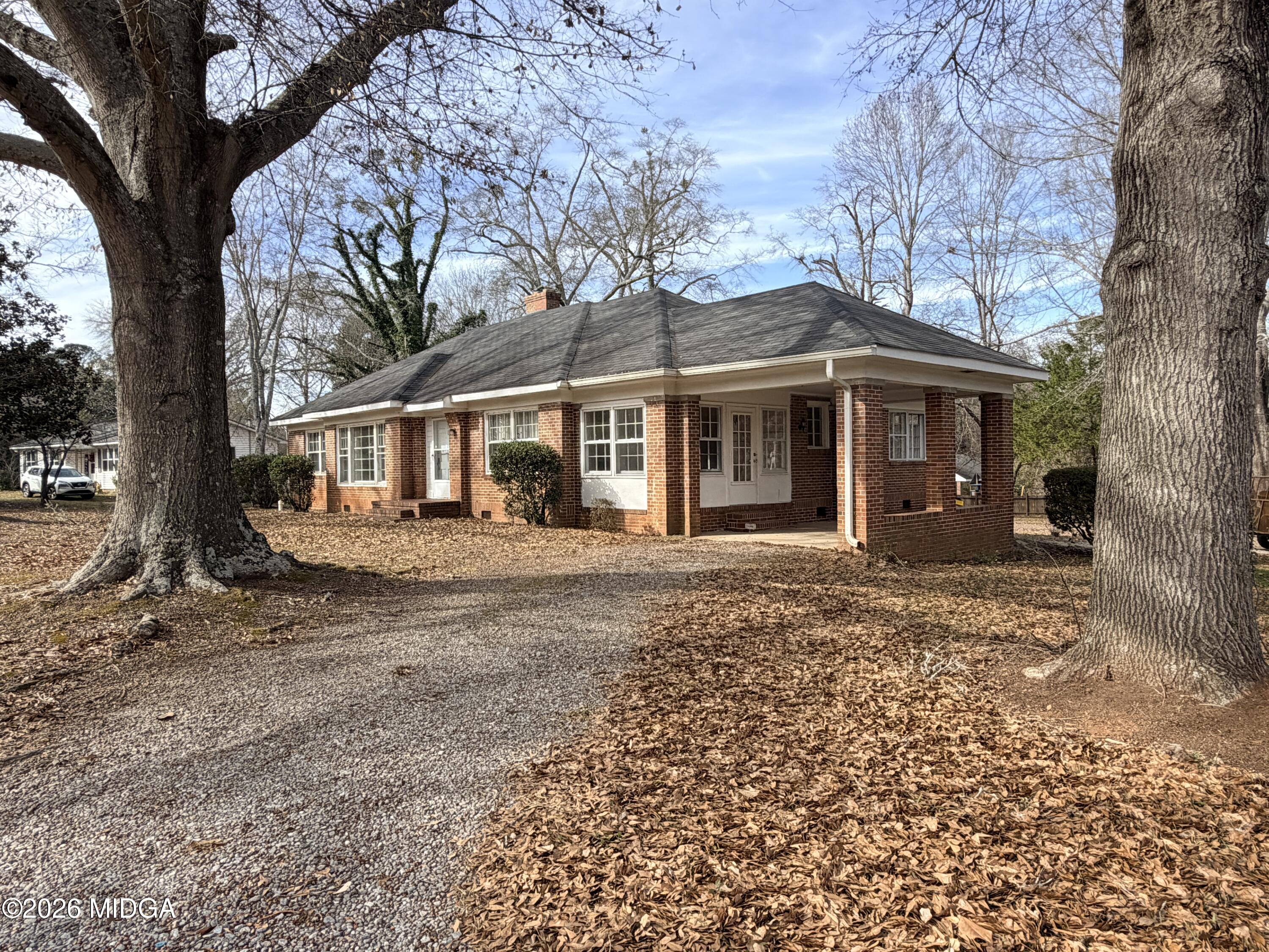419 West Johnston Street Forsyth, GA 31029 - Photo 2 of 34 front view of a house with a yard
