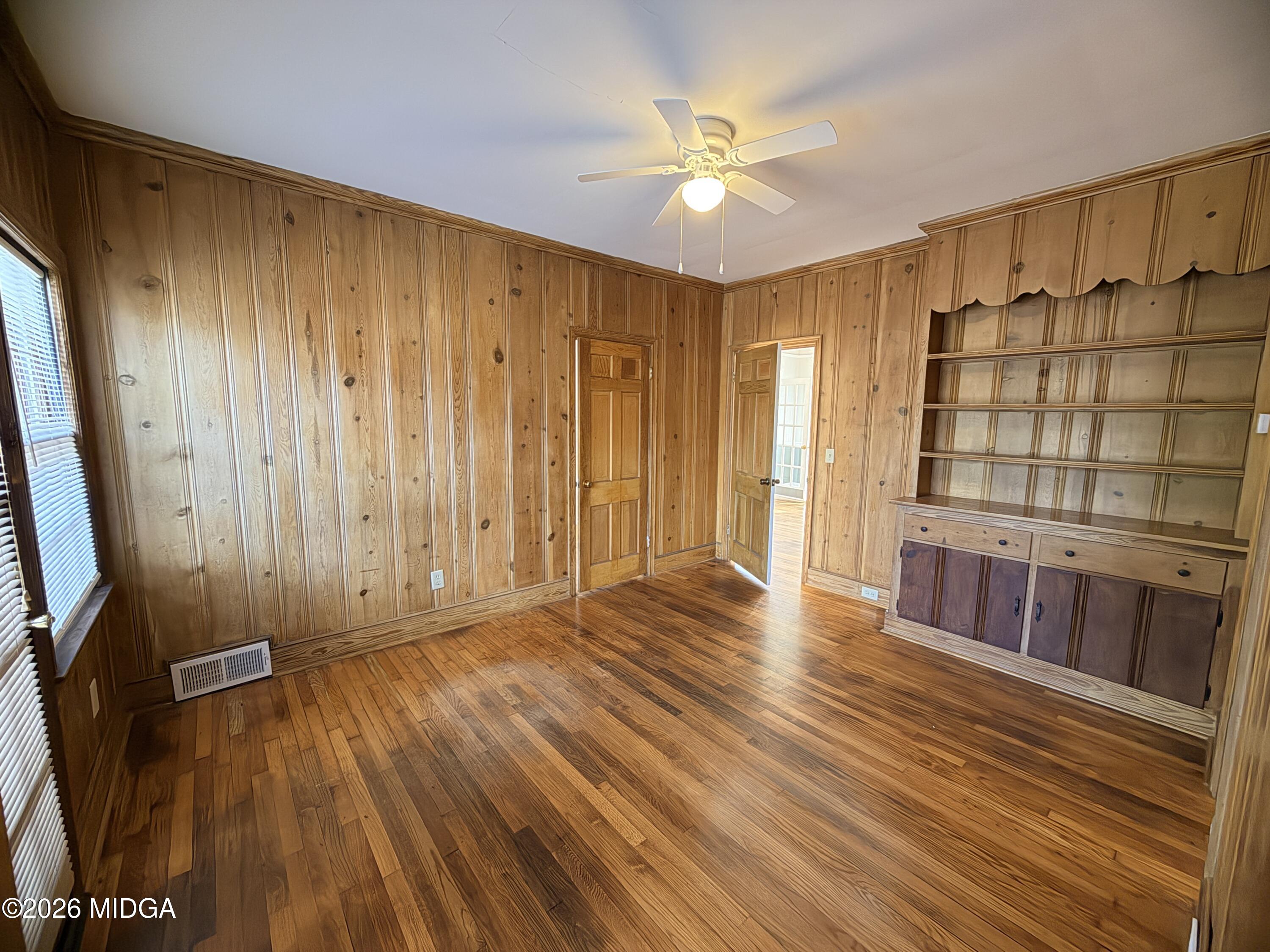 419 West Johnston Street Forsyth, GA 31029 - Photo 22 of 34 a view of an empty room with a window and wooden floor
