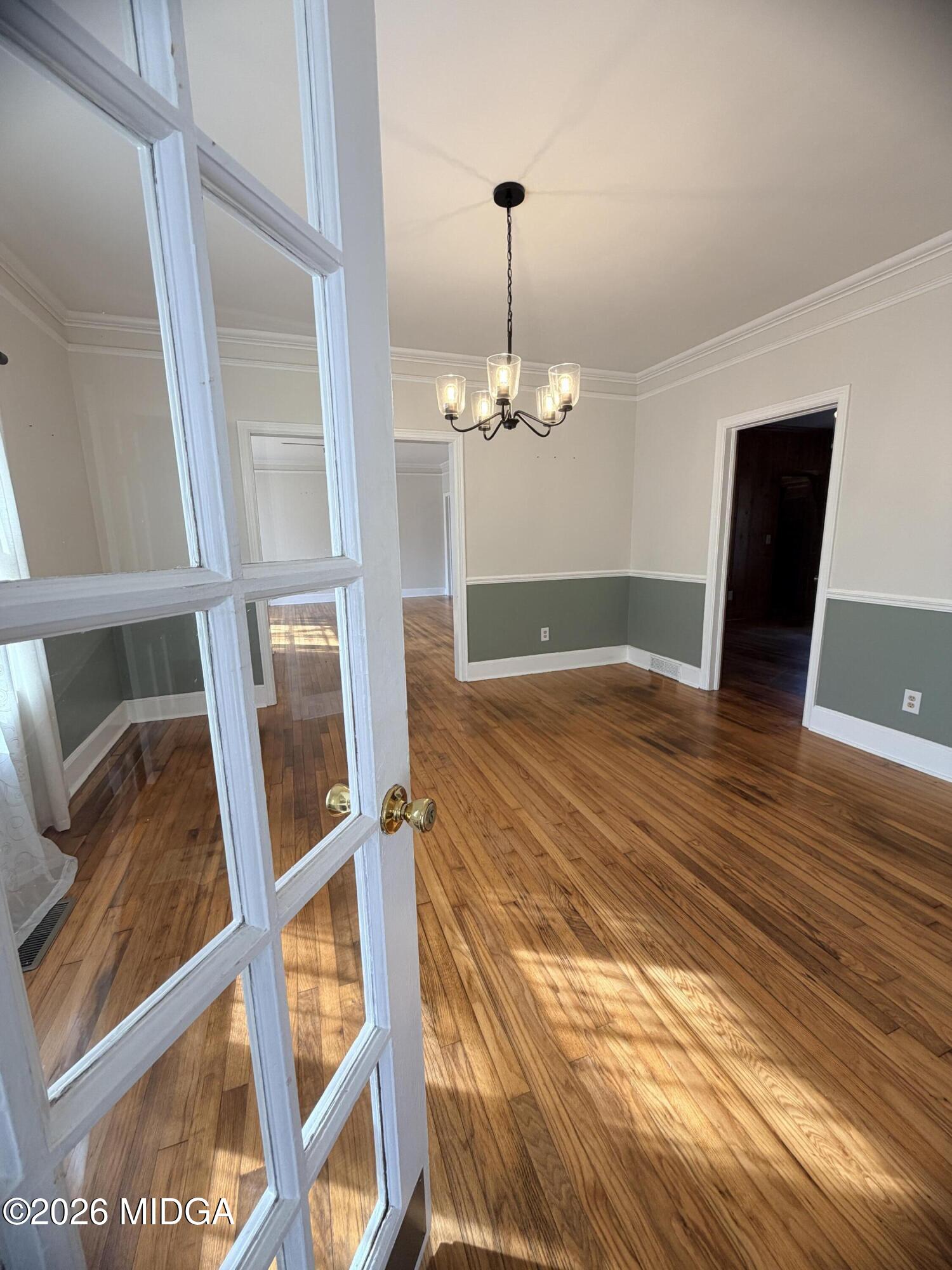 419 West Johnston Street Forsyth, GA 31029 - Photo 6 of 34 a view of an empty room with wooden floor and chandelier