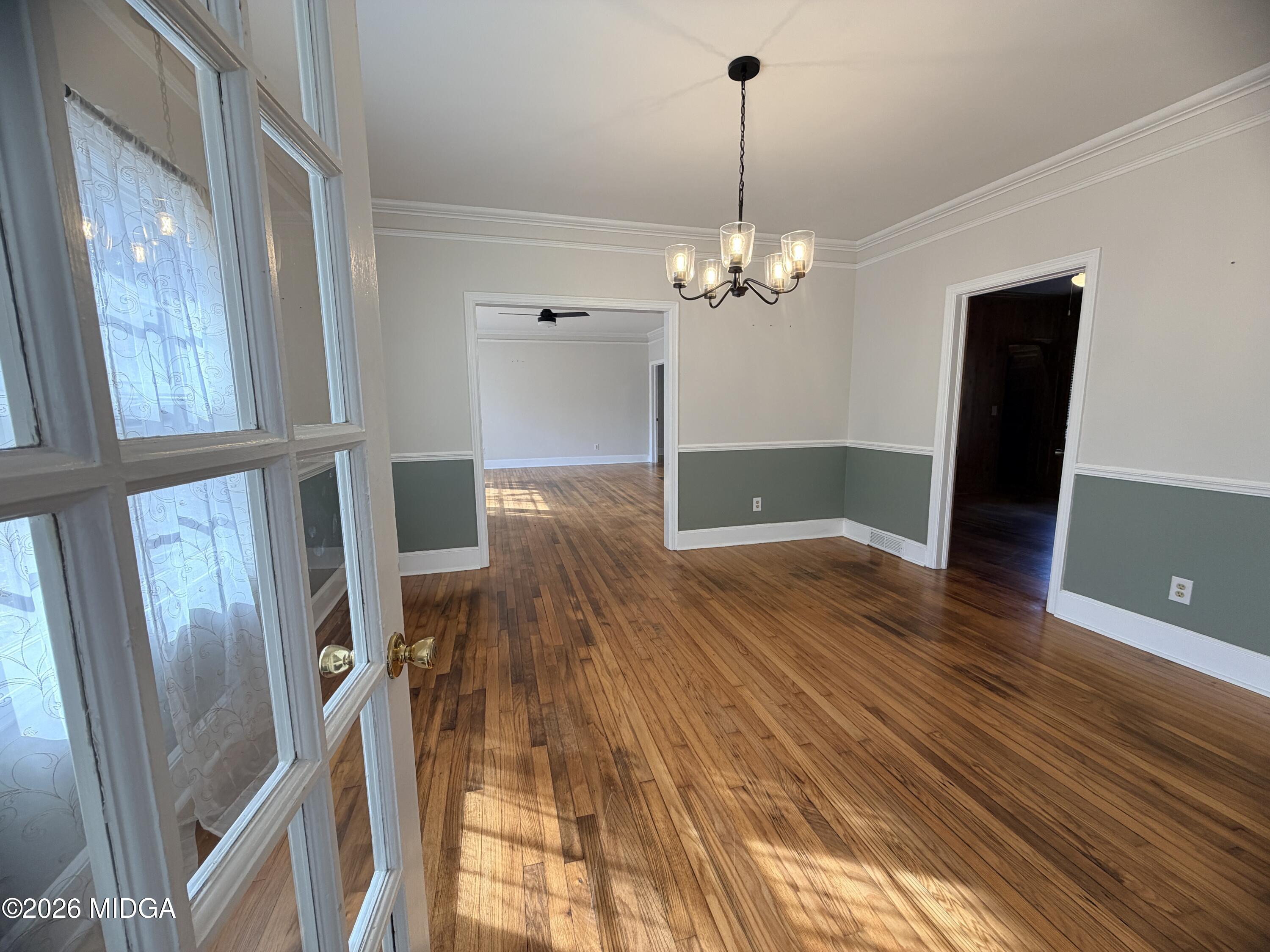 419 West Johnston Street Forsyth, GA 31029 - Photo 7 of 34 a view of a room with wooden floor and staircase