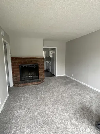 a view of empty room with a fireplace