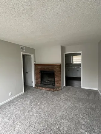 an empty room with fire place and fireplace