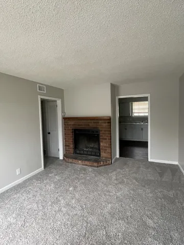 an empty room with fire place and fireplace